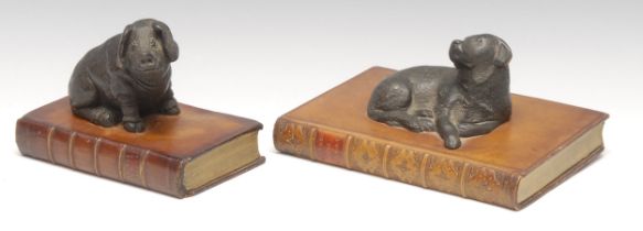 Interior Decoration - a cold cast desk model, of a dog, recumbent upon a leather bound book, 18.