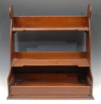 A 19th century mahogany wall shelf, possibly from a ship's cabin, scroll sides, sliding lower