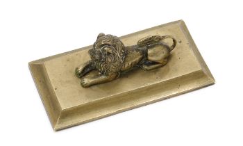 A Regency bronze desk weight, cast as a recumbent lion, spreading rectangular base, 13cm wide, c.