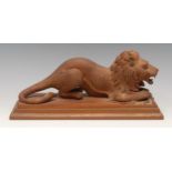 An early 20th century carving, of a lion and his kill, rectangular base, 29cm long