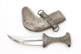 A Yemeni silver coloured metal jambiya dagger, 16cm curved blade with central ridge, chased scabbard
