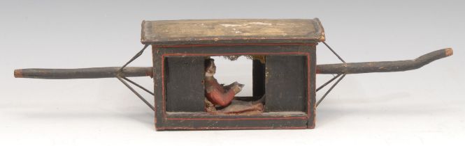 An Indian painted softwood model, of a palanquin, with European occupant, 33cm overall, 19th century