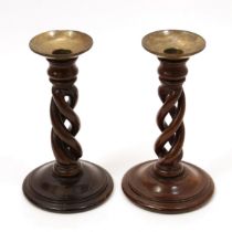 Treen - a pair of 19th century mahogany open-twist table candlesticks, brass sconces, domed circular