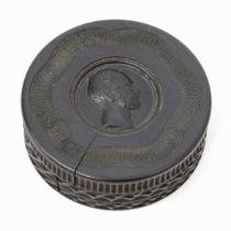 A 19th century lignum vitae circular snuff box, engine turned, screw-fitting cover centred by a