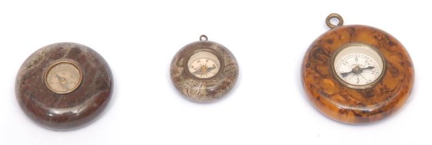 An early 20th century Cornish serpentine miniature compass, 3cm diam; another, similar, smaller;