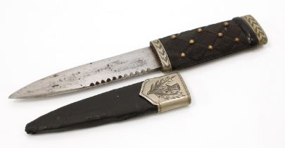 A Scottish sgian dubh dagger, 11cm blade with serrated spine, ebony faux-woven hilt, bright-cut