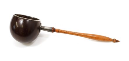 A 19th century sailor's coconut shell dipper, possibly American, turned handle, 38.5cm long overall,