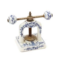 Nutcrackers - a 19th century German porcelain table top screw-action nut cracker, decorated in tones