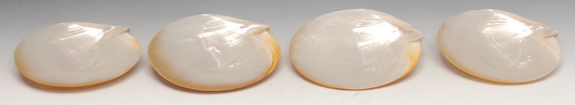 A set of four mother of pearl shell dishes, 22cm wide