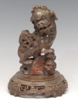 A Chinese soapstone carving, of a temple lion, bronze base, 18.5cm high