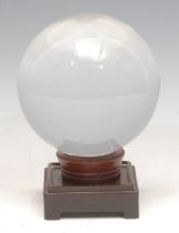 Mysticism and the Occult - a crystal ball, hardwood stand, 15cm high overall
