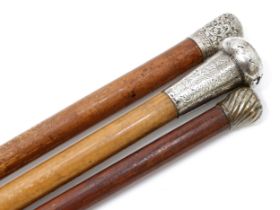 A George V silver mounted walking stick, the substantial pommel engraved with scrolling foliage,