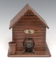 An early 20th century oak novelty cigar or tobacco box, as a dog and kennel, hinged cover, a vesta