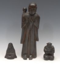 A Chinese carving, of Buddha and a child, standing, with serene expression, 36.5cm high; others (3)