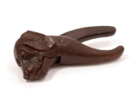 Nutcrackers - a Black Forest lever-action novelty nut cracker, carved as the head of a dog, 19.5cm