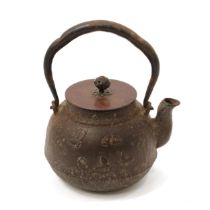 A Japanese cast iron tetsubin kettle, swing handle, the bronze cover signed to verso, 12.5cm long,