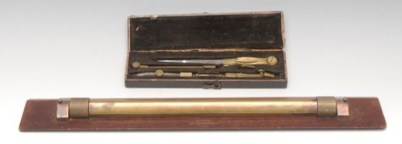 A World War II period brass and bakelite rolling rule, marked B7622 Astonmanda, 38cm long, dated