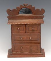 A 19th century tramp art chest, shaped cresting with arched mirror, above two short and two long