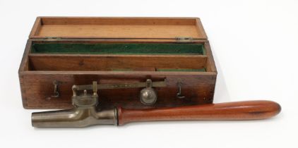 An early 20th century brass pressure testing instrument, turned mahogany handle, 45cm long (