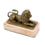 An early 20th century gilt cabinet bronze, of a recumbent lion, rectangular rose marble base, 9.