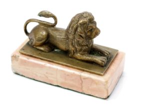 An early 20th century gilt cabinet bronze, of a recumbent lion, rectangular rose marble base, 9.