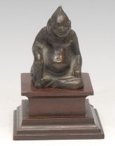 Erotica - a Chinese bronze erotic figure, in allusion to Budai, his genitalia visible beneath,