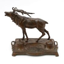 An early 20th century spelter novelty inkstand, cast with a stag, hinged covers, 27cm wide