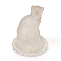 A 19th century pressed glass model, of a dog, seated, shaped circular base, 13cm high, c.1880