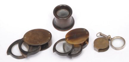 A 19th century horn pocket lens, 4cm wide; others (4)