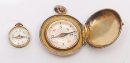 A 19th century gilt metal compass watch fob, of locket form, 2.5cm diam; another, miniature (2)