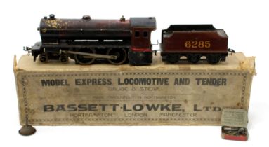 A Bassett-Lowke O Gauge tinplate and live steam 4-4-0 'Model Express' locomotive and six wheel