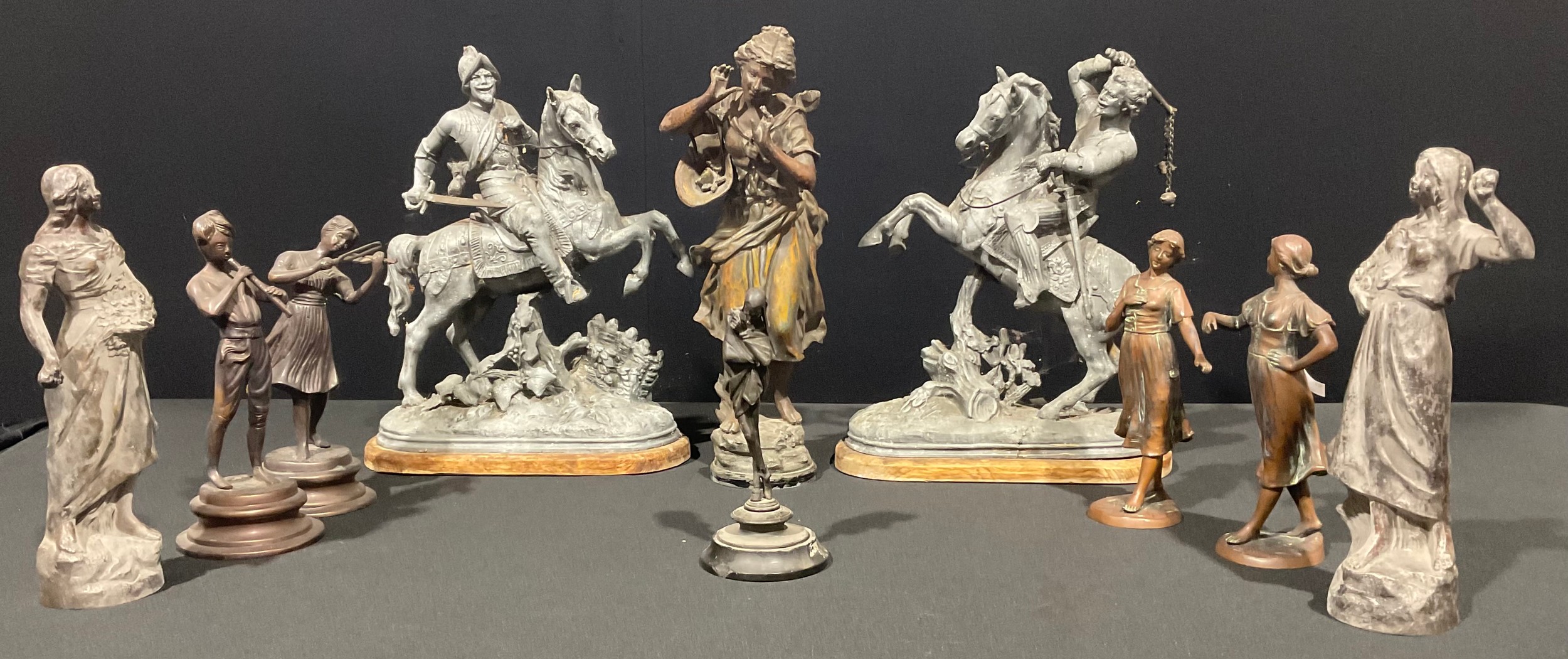 A pair of early 20th century spelter figures, as armoured horsemen, discorectangular wooden bases,
