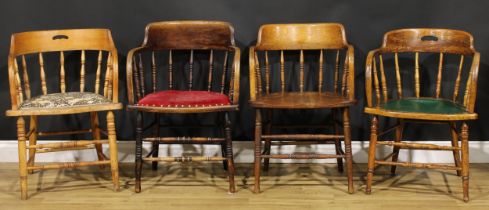 A harlequin suite of four early 20th century spindle back elbow chairs, the tallest 80cm high,