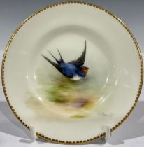 A Royal Worcester plate, decorated by W. Powell, signed, painted with a swallow bird, 12cm diameter,
