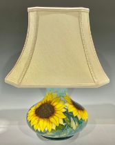 A contemporary Moorcroft Sunflower pattern compressed ovoid table lamp, tube-lined in tones of