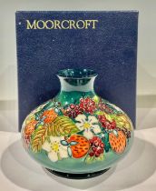 A contemporary Moorcroft Carousel pattern compressed ovoid vase, tube lined with strawberries and