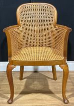 An early 20th century walnut bergère elbow chair, cabriole forelegs, 85.5cm high, 59.5cm wide, the