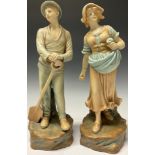 A pair of Continental porcelain figures, Farm Girl and Boy, after Schoop, 35cm high