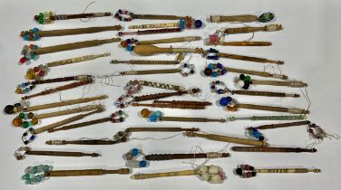 A collection of 19th century lace maker's bobbins, including glass, bone and wood, some with