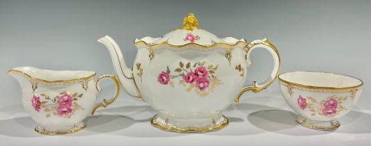 A Royal Crown Derby Royal Pinxton Roses teapot and cover, second quality; a cream jug, first