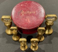 A set of Victorian brass weights in a leather collar box