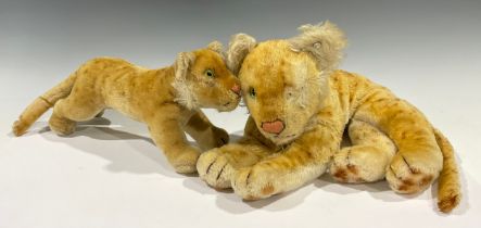 Toys & Juvenalia - a 1950's/1960's Steiff (Germany) mohair Lion, lying flat, 30cm long; another on