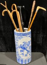 A 20th century Chinese stick stand/umbrella stand, decorated in blue and white with fanciful
