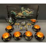 A mid century Japanese style lacquer and gilt tea service for six, depicting a river scene with
