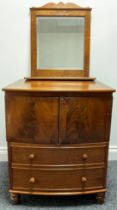 A Victorian mahogany bow front night chest, the top lifting above a pair of flame veneered drawers