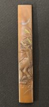 Japanese Kozuka knife handle featuring a Wolf, signed, 95mm in length. Complete with a wooden