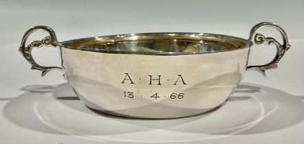 A silver two-handled bowl, scroll handles