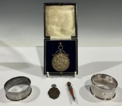 A Georve V silver horticultural medal, Violas 1932, silver pendant mount, boxed; two silver napkin