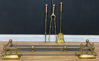 A 19th century brass hearth suite, comprising fire curb or fender, irons and andirons, c.1890