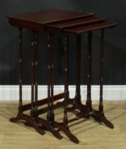A nest of three George III Revival mahogany occasional tables, each with a rectangular top, turned